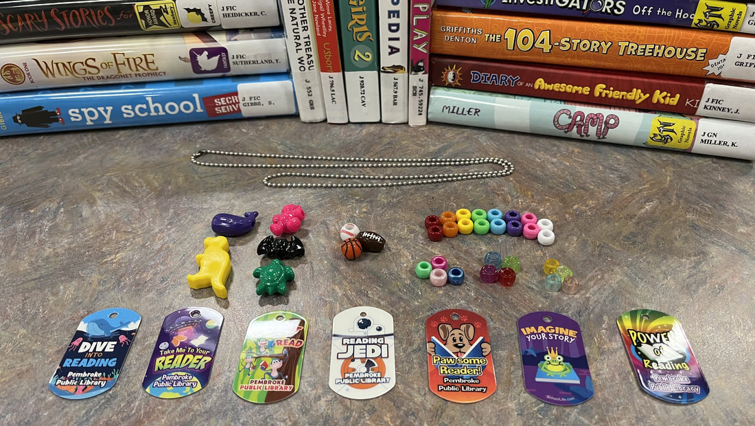 A row of plastic tags is laid next to small piles of multi-color beads.