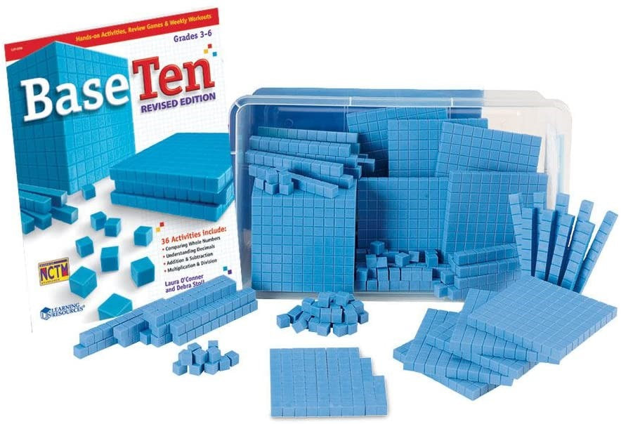 ID: Clear filled with rods, flats, cubes, and units laying on its side. Small piles have been made of each in front of the bin. To the left is a workbook standing up with its cover facing forward, the title Base Ten Revised Edition.